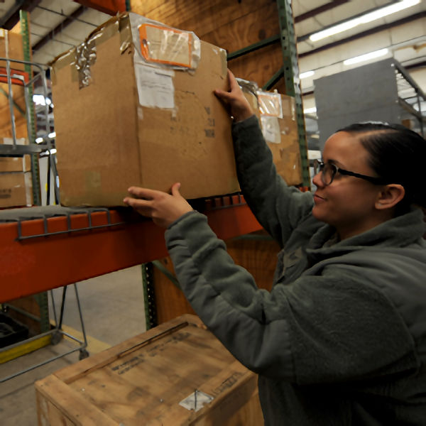 Worker Lifting Heavy Box Above Shoulders