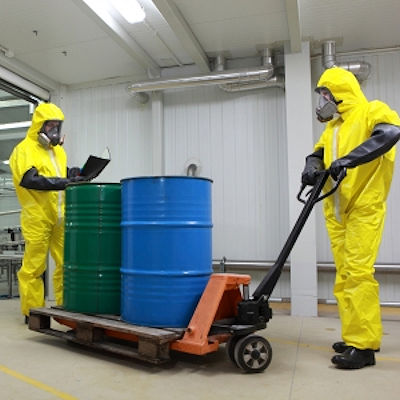 Image of trained employees safely moving hazardous chemicals on a cart