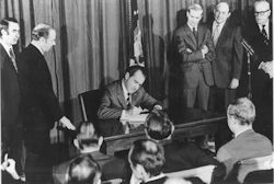 President Nixon signs OSHAct - public domain image.