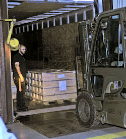 Picture of truck backed up to loading dock with dockboards to assist loading by forklift.