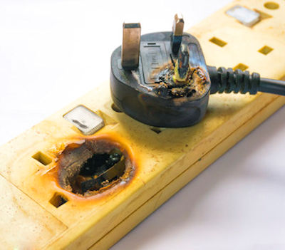 Overloaded electrical plug burnt and damaged.