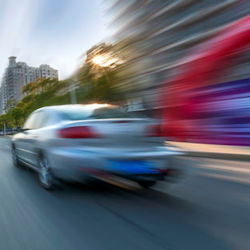 Speeding car driving away from camera