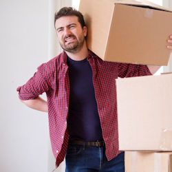 Worker with sore back carrying heavy load