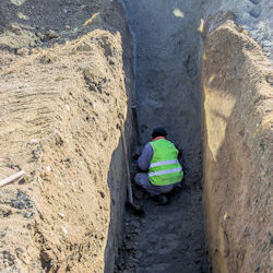 man in long deep trench