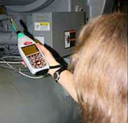 Worker using special hand-held equipment to take sound levels measurements