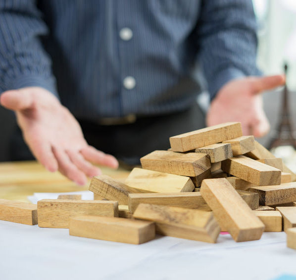 Worker trying to organize game parts in disarray