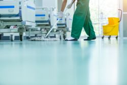 hospital employee mopping the floor