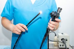 person in scrubs holding an endoscope