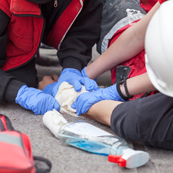 Image of Gloved Hand Giving First Aid to Patient