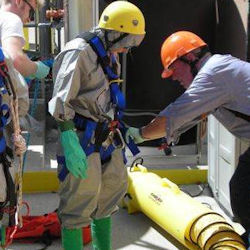 Workers entering a confined space with portable force-air ventilation