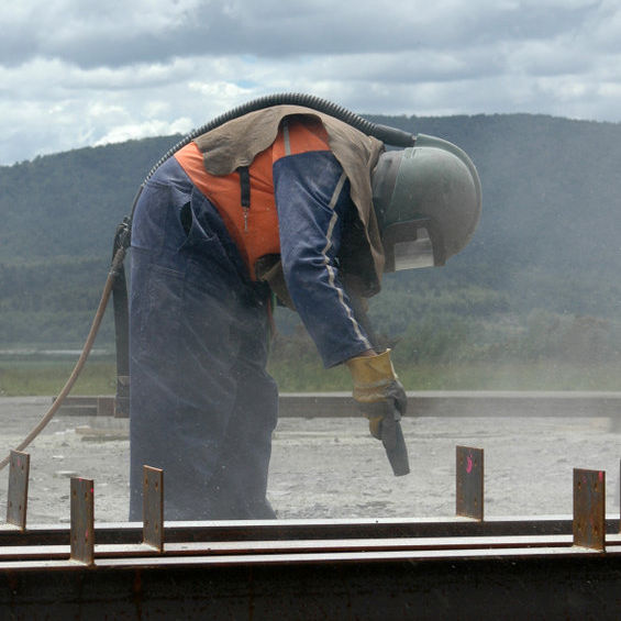 Worker sand blasting