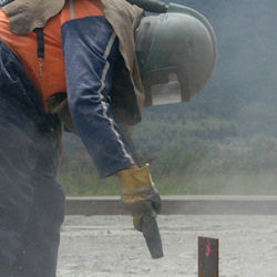 Worker sand blasting