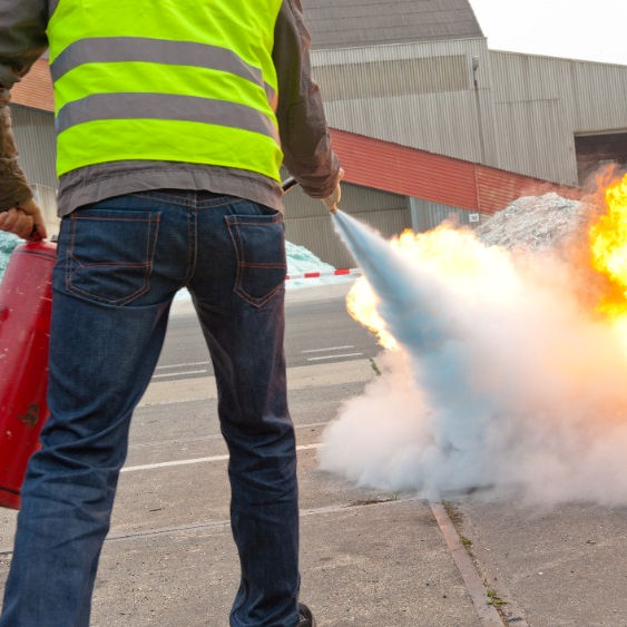 Employee practicing using a fire extinguisher