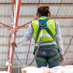 Worker at elevation with fall protection.