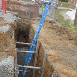 Long deep trench with bracing and ladder