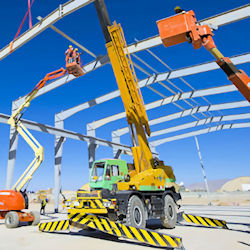 Multiple Steel erection equipment working on outdoor site