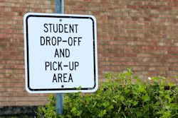 Sign in school area with drop-off and pick-up area sign