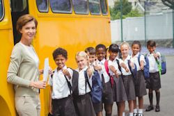 Teacher and childen lined up orderly before loading bus