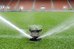 Working sprinkler system on sports field.