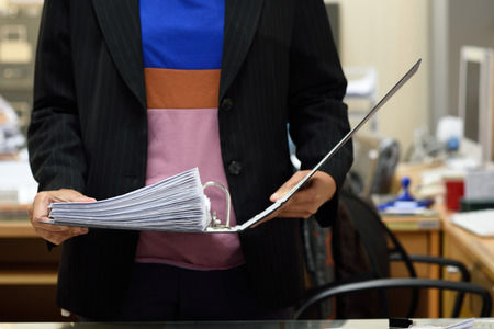 school staff member holding a notebook