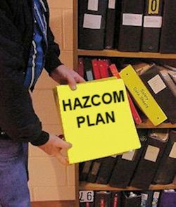 Yellow notebook shwoing HAZCOM Plan on the cover