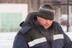 Outside worker wearing a heavy coat.