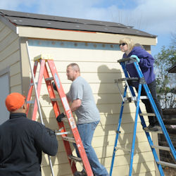 Two people climbing ladders.