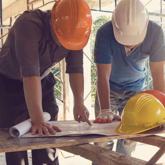 A qualified person and worker reviewing scaffold designs.