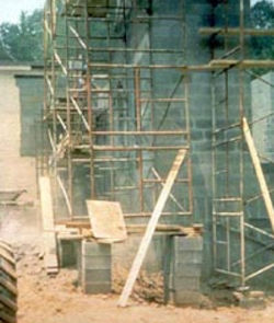 Base of scaffold placed on cement blocks that are stacked six high.