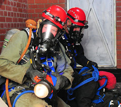 Two confined space team members receiving rescue training.