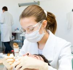 Dentist working on patients teeth.