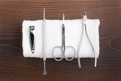 Nail salon tools drying on clean cloth.