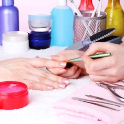 Worker applying nail polish.