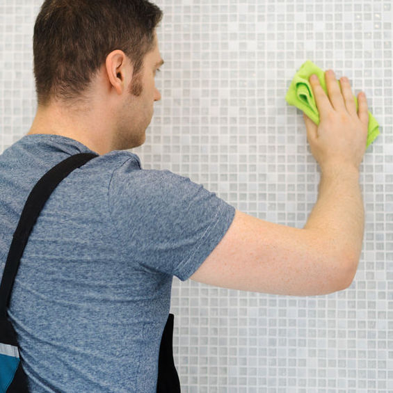 Worker cleaning shower