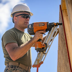 worker using a pneumatic nail gun