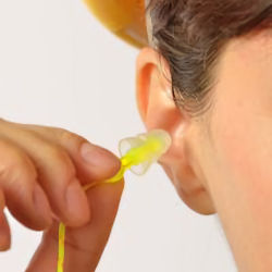 worker insering earplug