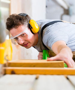 Worker wearing googles and hearing protection