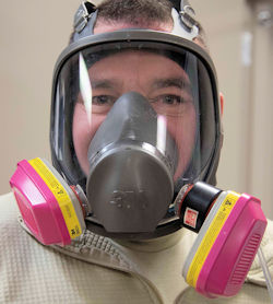 Man wearing respirator with cartridges