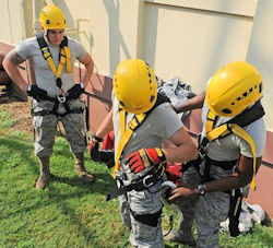 Three workers learning and training for personal fall arrest systems PFAS