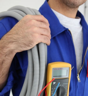 Electrician with tools over shoulder