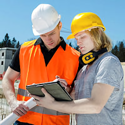 Two workers outdoors conducting inspection following notes in notebook