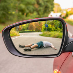 driver looking in side mirror sees victim laying in street