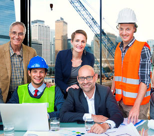 workers from company's various positions working as a team. Sitting at a desk with a open laptop.