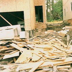 A house under construction with alot of debris on site.