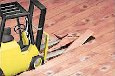 Forklift with forks sticking in a wooden floor.