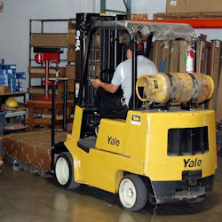 worker operating a traveling forklift