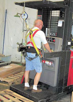 worker with PPE fall protection forklift