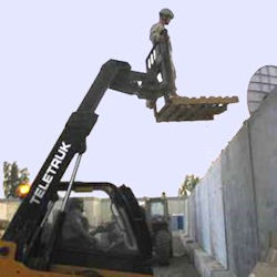 worker incorrectly being hoisted by a forklift