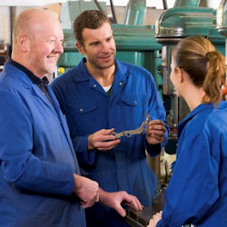 Three employees receiving on-the-job training