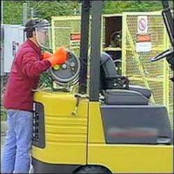 Worker parking Liquid Petroleum Gas forklift